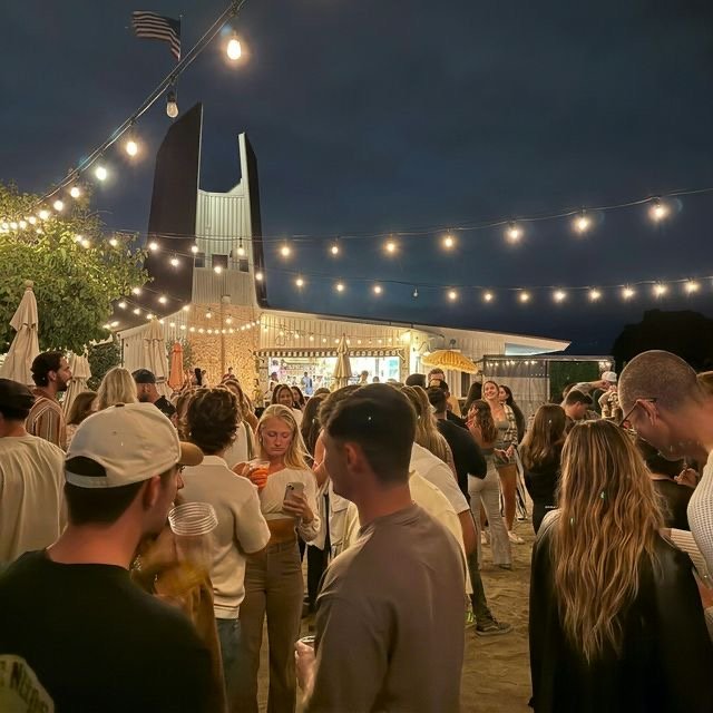 An evening gathering under the lights at Mission Bay Beach Club